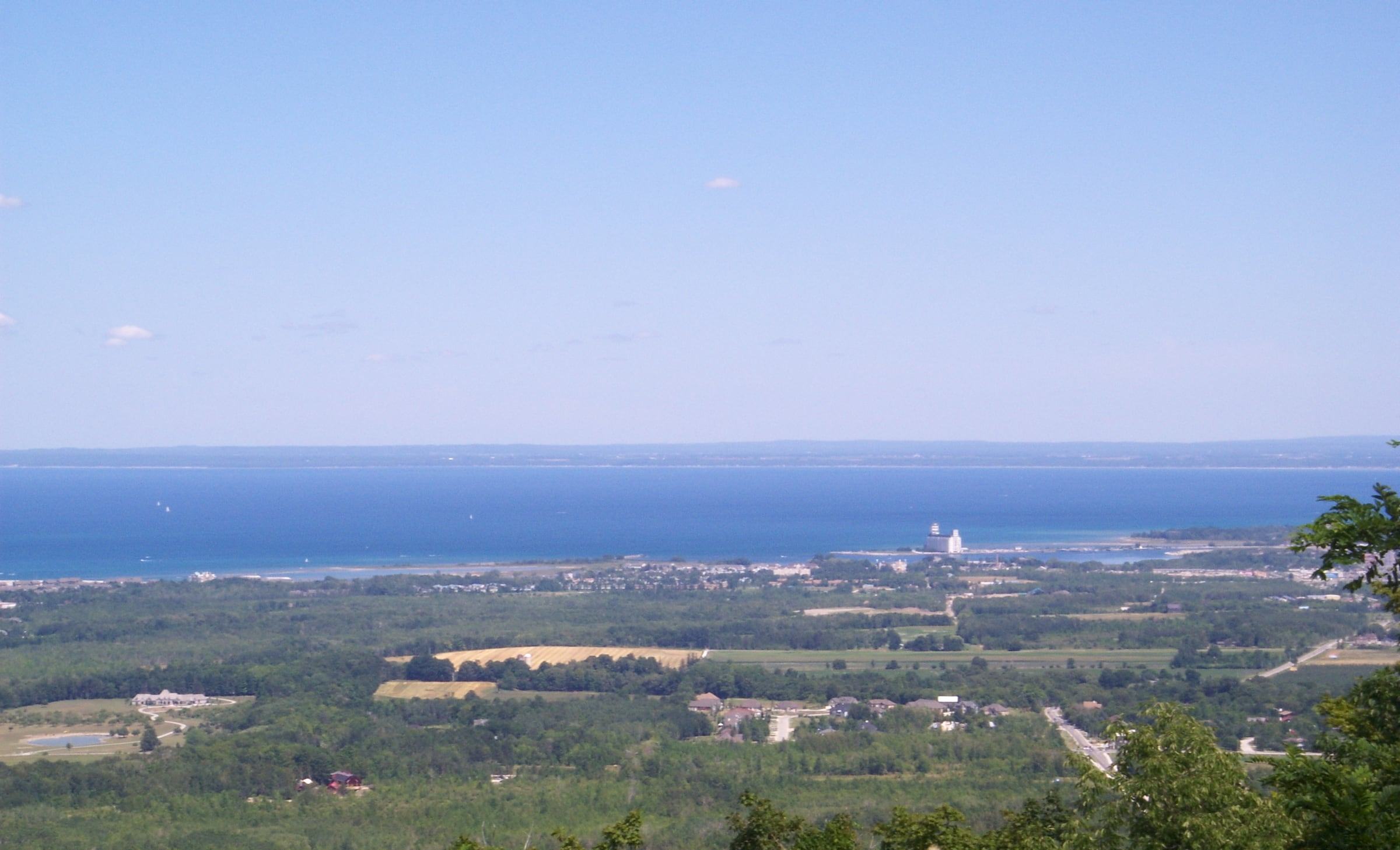 View from Blue Mountain over forest and Collingwood to the blue waters of Georgian Bay