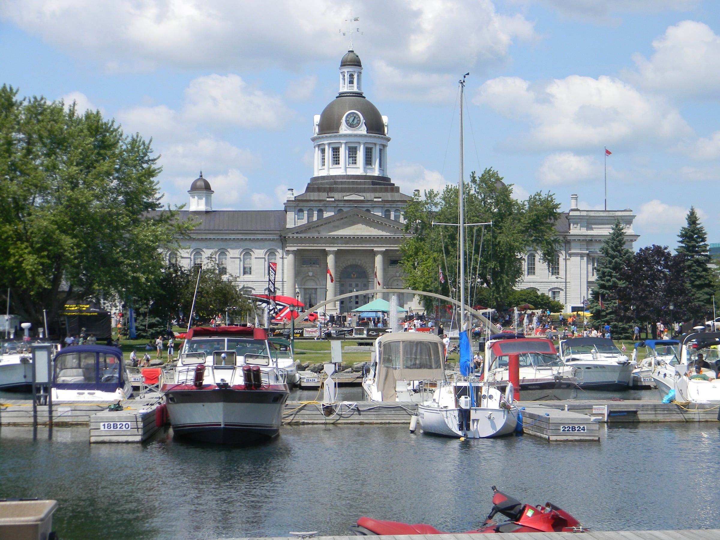 Kingston City Hall dome rising behind boats moored in the Confederation Basin marina
